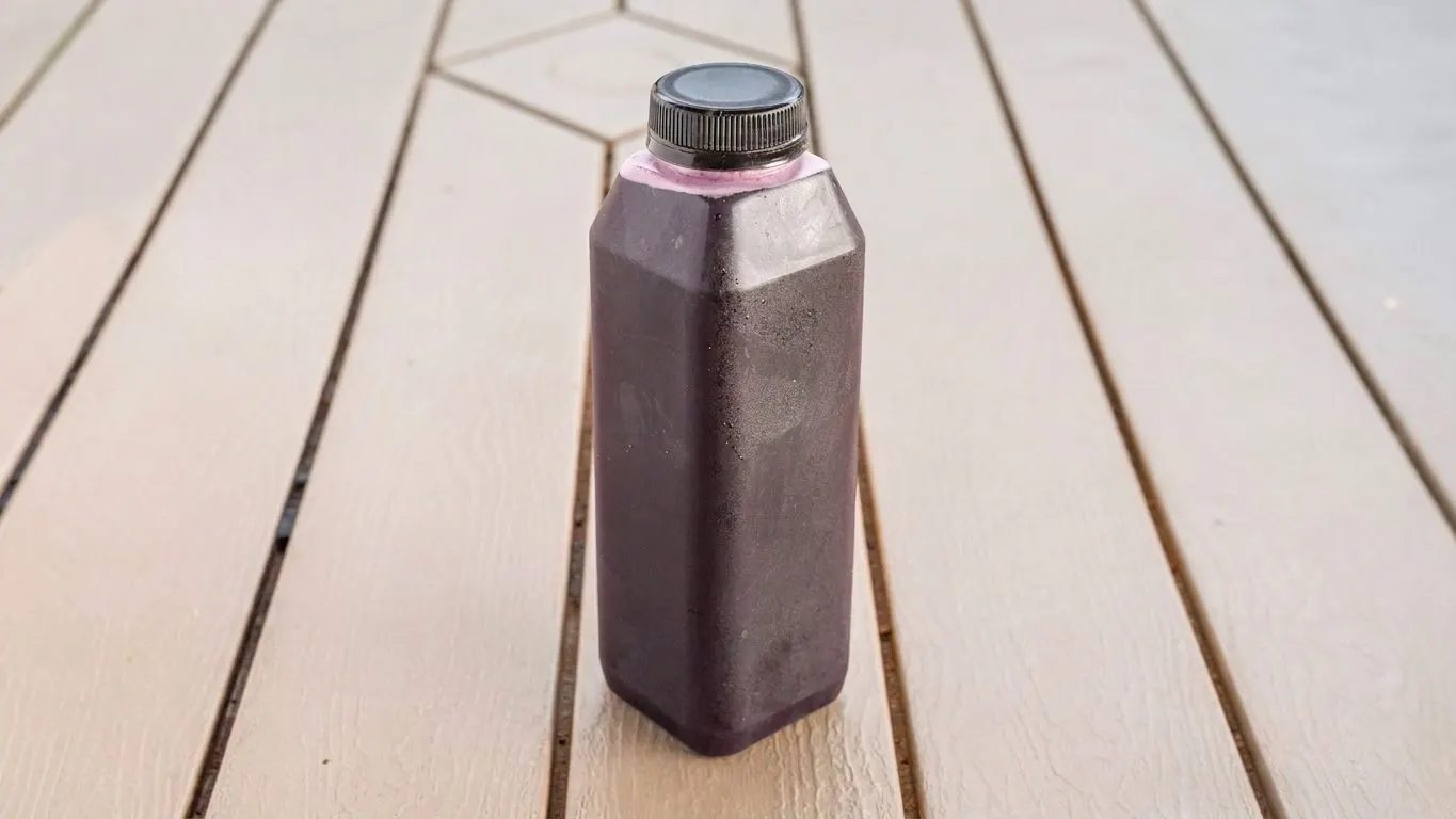Bottle of dark red hibiscus drink