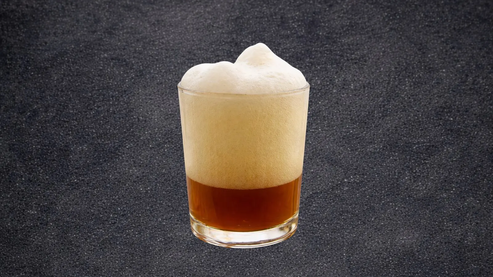 Glass of Saharan black tea with a thick foam on top